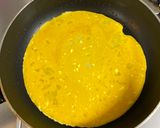 A picture of step 3 of Omu Sandwich (Sandwich wrapped with egg fry).