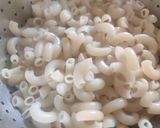 A picture of step 1 of Cheesy Macaroni in tomato and cream sauce.
