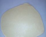 A picture of step 9 of Bow tie buns.