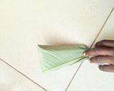 A picture of step 6 of How to tie moi moi leaf.
