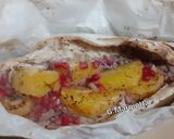 Foto del passaggio 5 della ricetta Branzino al cartoccio con erbe aromatiche, arancia e melagrana