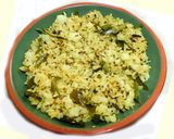A picture of step 5 of Fried rice topped with green veggies.