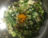 A picture of step 4 of Baingan bharta with green peas.