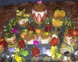 A picture of step 10 of Kunafa and Qashtalia Decorated with Oranges, Strawberries, and Bananas.