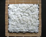 A picture of step 1 of Ura Maki-zushi (Inside-out Sushi Rolls).