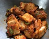 A picture of step 7 of Chatpata Bread Upma in red sauce.