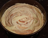 A picture of step 8 of White Layer Cake with a Raspberry Swirl Cheesecake center layer and a Raspberry Cream Frosting.
