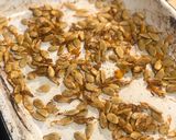 A picture of step 7 of Tray bake pumpkin & chicken thighs topped with roast pumpkin seeds.