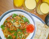 A picture of step 5 of Chicken Karahi with chapati and mango shake.