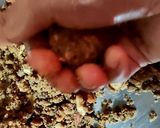 A picture of step 6 of Wheat flour seeds and nuts Ladoo with leftover ghee residue.