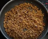 A picture of step 2 of My version of Thai Basil Beef (Pad Ka Prao) with dried chillies, topped with fried eggs.