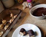 A picture of step 4 of Chocolate Covered Frozen Banana Peanut Butter Sandwiches.