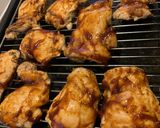 A picture of step 1 of Sticky bbq chicken thighs served with sweet potato chips and a crisp lemon salad.