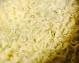 A picture of step 1 of Chicken schezwan Maggi noodles and tossed boiled egg with Maggi seasoning.