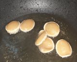 A picture of step 6 of Indian snack (crisp sphere with flavoured water/curd mixture).