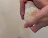 A picture of step 3 of Onigiri with bonito flakes and cheese.