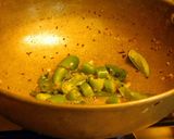 A picture of step 4 of Fried rice topped with green veggies.