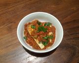 A picture of step 7 of Papad stuffed with paneer in tomato and onion gravy.