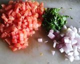 A picture of step 1 of Sweet and sour tomato bhaji.