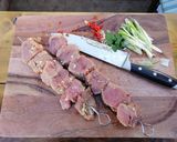 A picture of step 3 of Asian style pork kebabs, steamed veg and yellow rice.