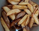 A picture of step 3 of My salt pepper & Chilli Wedge Chips 😅.