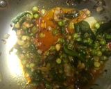 A picture of step 4 of Baingan bharta with green peas.