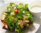 A picture of step 6 of Crab Stick Salad Rolls with Wasabi Dressing - Bento Box Menu.