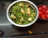 A picture of step 1 of Aloo chorifali and tomato sabji.