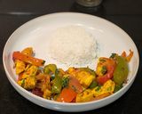 A picture of step 9 of Paneer Jalfrezi with steamed white rice.