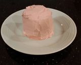 A picture of step 17 of Vanilla Butter Cakes filled and Frosted with Whipped White Chocolate Rasberry Ganache.