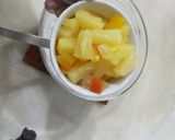 A picture of step 3 of Pineapple delight with m&m bunties.