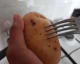 A picture of step 1 of Maggi stuffed jacket potatoes.