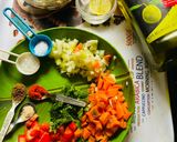 A picture of step 1 of Sprout Salad with carrots cucumber tomatoes.