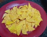 A picture of step 4 of Doritos (nachos chips) in cheese sauce.