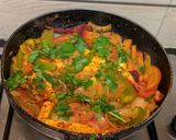 A picture of step 9 of Paneer Jalfrezi with steamed white rice.
