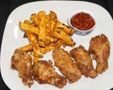Foto del paso 6 de la receta: Alas de pollo adobadas y bastones de camote amarillo asado