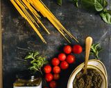 A picture of step 1 of Basil pesto spaghetti with loads of cherry tomatoes.
