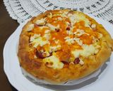 A picture of step 5 of Pizza covered with homemade Mozzarella Cheese & Sausage.