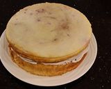 A picture of step 28 of White Layer Cake with a Raspberry Swirl Cheesecake center layer and a Raspberry Cream Frosting.
