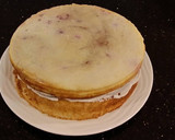 A picture of step 28 of White Layer Cake with a Raspberry Swirl Cheesecake center layer and a Raspberry Cream Frosting.