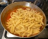 A picture of step 8 of Penne al'arrabiata (pasta with a spicy tomato sauce).