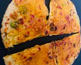 A picture of step 2 of Stuffed Leftover Rice Paratha topped with Schezwan Sauce.