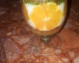 A picture of step 7 of Kunafa and Qashtalia Decorated with Oranges, Strawberries, and Bananas.