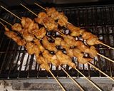 A picture of step 7 of Chicken paprika drums Skewered red hot Shrimps and grilled sausages.