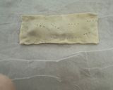 A picture of step 5 of Puff Pastry Twists with 'Nduja Spread, Speck, and Ragusano Cheese.