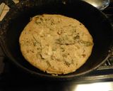 A picture of step 3 of Nutritious, aromatic, spicy corn flour Uthappam wih green leaves.