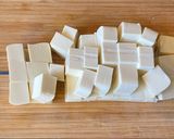 A picture of step 4 of Steamed tofu with sweet soy dressing sauce and spring onions.