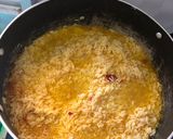 A picture of step 1 of Fried rice n plantain with chicken sauce garnished with kale leaf.
