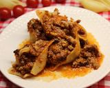 Une image de l'étape 12 de Conchiglioni à la bolognese gratinés.
