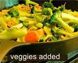 A picture of step 5 of Multi colored pilaf with broccoli, red and orange bell peppers, and carrots.
